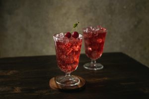 Refreshing THC-infused cranberry mocktail served over ice.